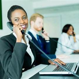 Office staff member answering a phone call in a professional workspace